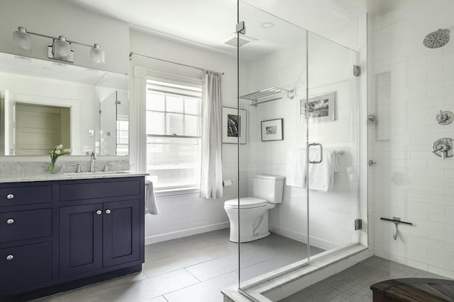 full bath featuring vanity, toilet, tile patterned flooring, and a stall shower