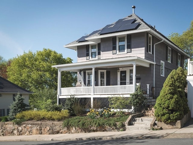traditional style home featuring solar panels, stairs, and a porch