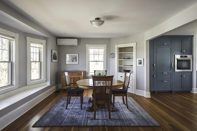 dining area featuring dark wood-type flooring, baseboards, and a wall unit AC