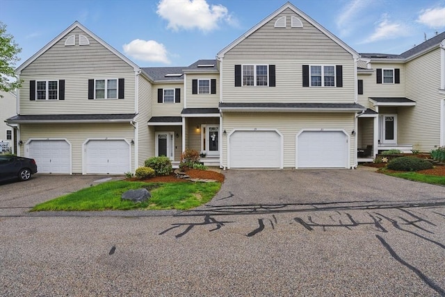 view of property with driveway and an attached garage