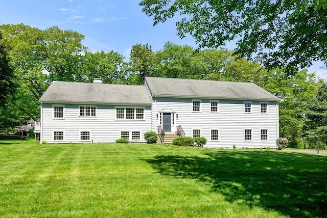 64 Bakers Hill Rd, Weston, MA 02493 - back of property featuring a yard, a chimney, and view of wooded area