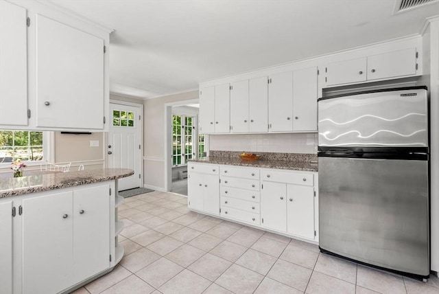 64 Bakers Hill Rd, Weston, MA 02493 - kitchen with freestanding refrigerator, white cabinets, backsplash, light tile patterned flooring, and stone counters