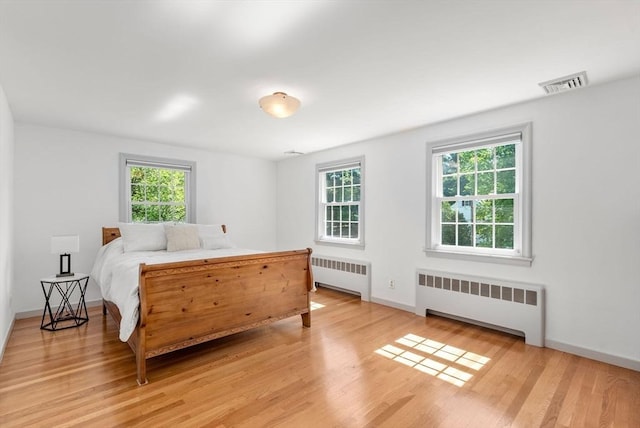 64 Bakers Hill Rd, Weston, MA 02493 - bedroom with radiator, light wood-type flooring, and baseboards
