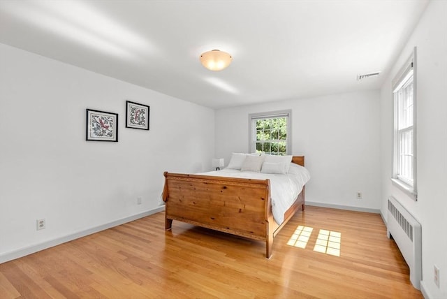 64 Bakers Hill Rd, Weston, MA 02493 - bedroom with radiator, light wood-style floors, and baseboards