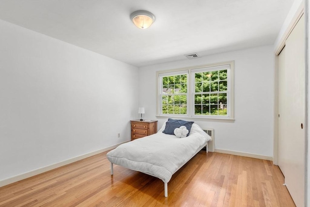 64 Bakers Hill Rd, Weston, MA 02493 - bedroom with light wood finished floors, radiator, a closet, and baseboards