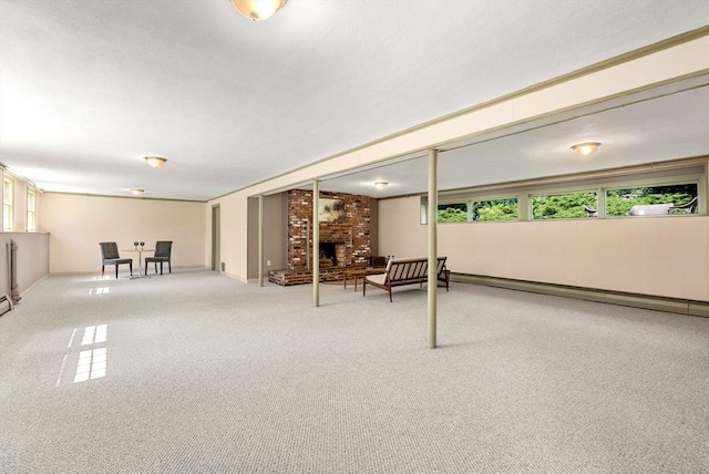 64 Bakers Hill Rd, Weston, MA 02493 - below grade area with a brick fireplace, carpet, and baseboard heating