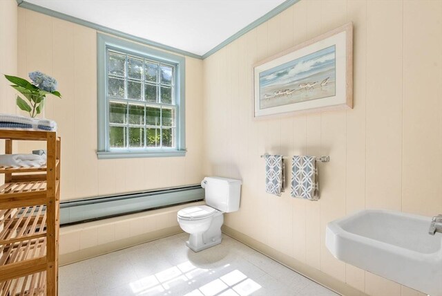 64 Bakers Hill Rd, Weston, MA 02493 - bathroom with a baseboard heating unit, toilet, a sink, crown molding, and tile patterned floors