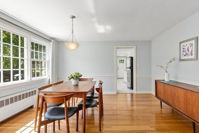 64 Bakers Hill Rd, Weston, MA 02493 - dining area with radiator heating unit and light wood-style floors