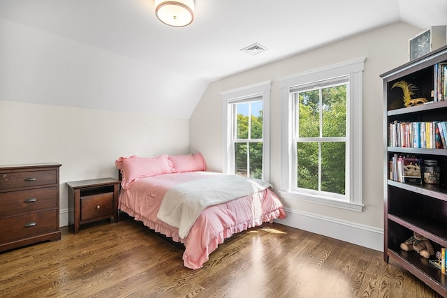 bedroom with lofted ceiling and dark hardwood / wood-style floors