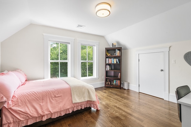 bedroom with lofted ceiling and hardwood / wood-style flooring