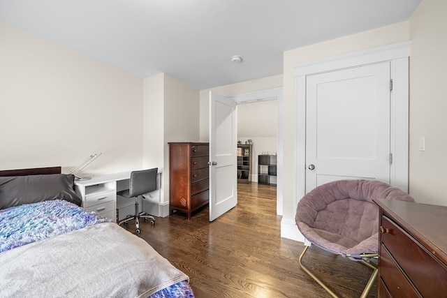 bedroom with dark hardwood / wood-style flooring