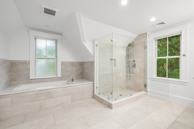 bathroom featuring plenty of natural light, tile patterned floors, and separate shower and tub