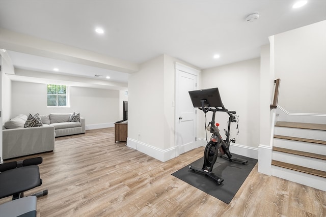 exercise room with light hardwood / wood-style flooring