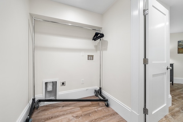 laundry room featuring washer hookup, light hardwood / wood-style flooring, and hookup for an electric dryer