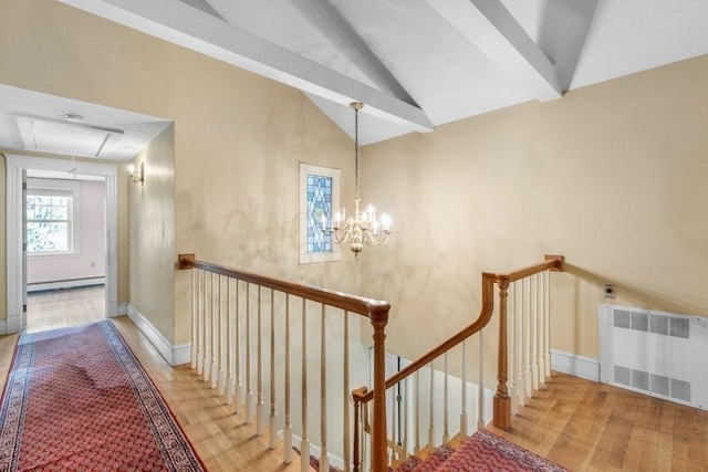 staircase with radiator, wood finished floors, attic access, baseboard heating, and lofted ceiling with beams