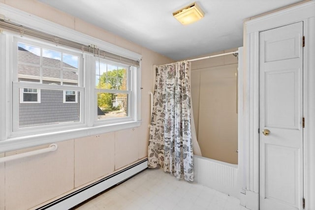 full bath featuring a shower with curtain and a baseboard heating unit