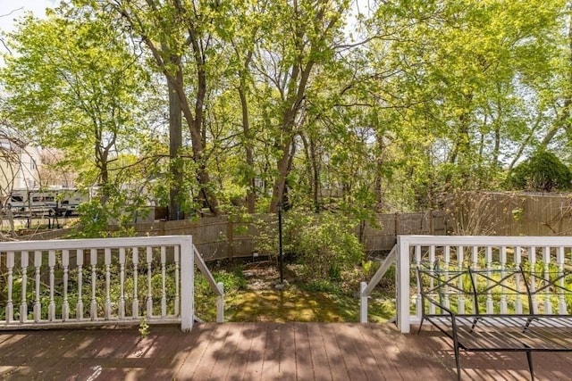 wooden terrace featuring a fenced backyard