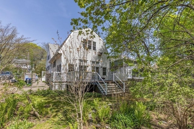 exterior space with a wooden deck and stairs