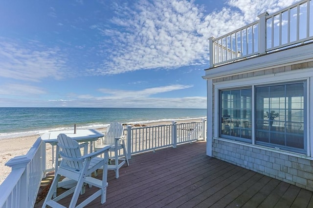 deck with a water view and a beach view