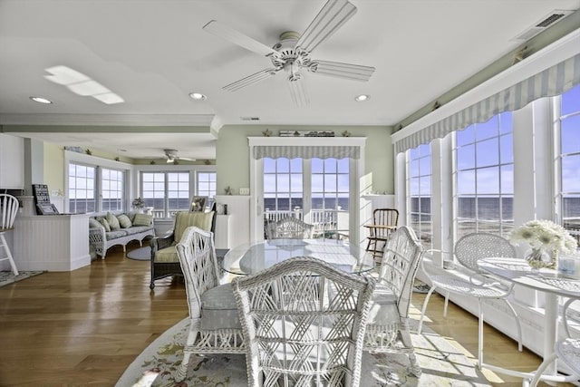 sunroom / solarium featuring ceiling fan