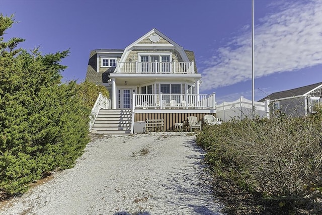 view of front of property featuring covered porch and a balcony