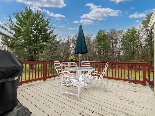 13 Independence Ln, Millis, MA 02054 - deck featuring outdoor dining area, view of wooded area, and a grill