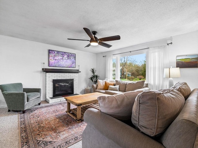 13 Independence Ln, Millis, MA 02054 - living area featuring ceiling fan, a fireplace, and a textured ceiling