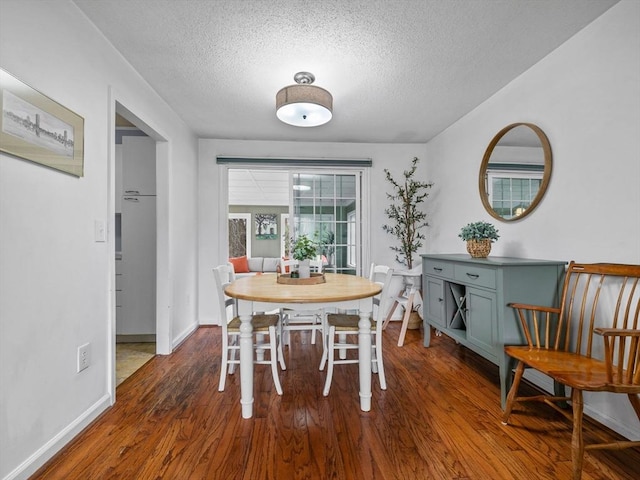 13 Independence Ln, Millis, MA 02054 - dining area with dark wood-type flooring, a textured ceiling, and baseboards