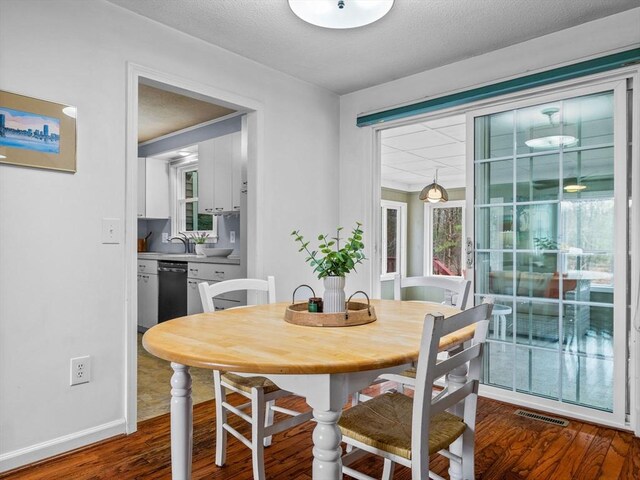 13 Independence Ln, Millis, MA 02054 - dining space with dark wood-style flooring and baseboards
