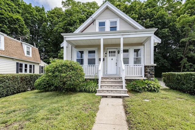108 Arlington Rd, Woburn, MA 01801 - view of front facade featuring a porch, a front lawn, and stone siding