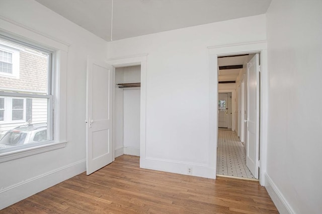 108 Arlington Rd, Woburn, MA 01801 - unfurnished bedroom featuring light wood-style flooring and a closet