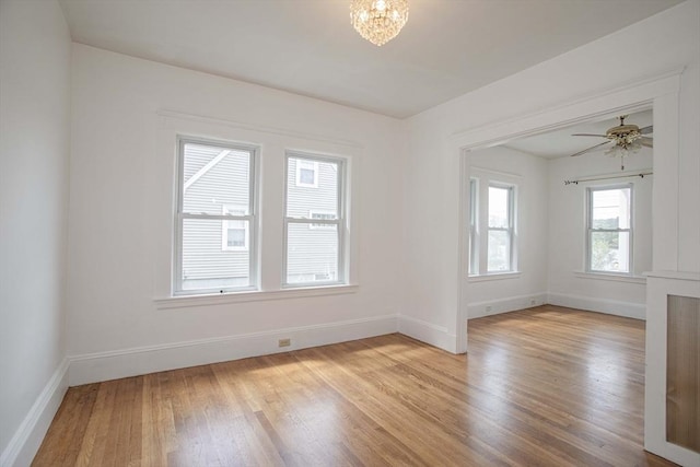 108 Arlington Rd, Woburn, MA 01801 - spare room featuring light wood-style flooring, a chandelier, and a ceiling fan
