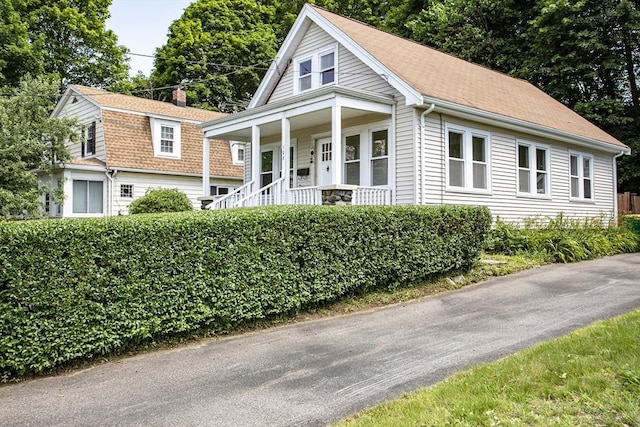 108 Arlington Rd, Woburn, MA 01801 - view of front facade with a porch and a chimney