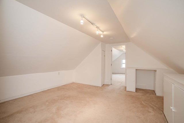 108 Arlington Rd, Woburn, MA 01801 - additional living space with light carpet, vaulted ceiling, and washer / dryer