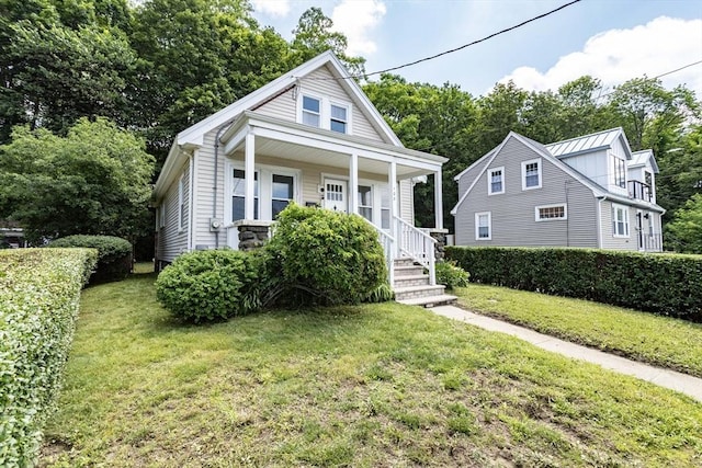 108 Arlington Rd, Woburn, MA 01801 - bungalow with a front lawn and a porch