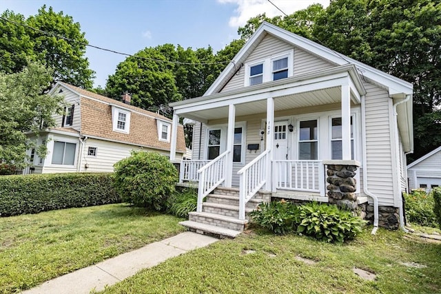 108 Arlington Rd, Woburn, MA 01801 - view of front of property with a front yard, a porch, and stone siding