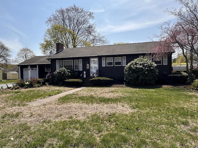 ranch-style house with a chimney, an attached garage, roof with shingles, and a front lawn