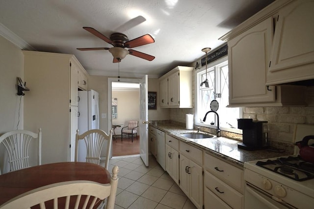 kitchen with backsplash, white appliances, light tile patterned floors, a sink, and ceiling fan