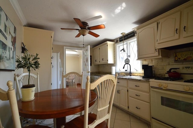 kitchen featuring a sink, tasteful backsplash, white appliances, ceiling fan, and light tile patterned floors