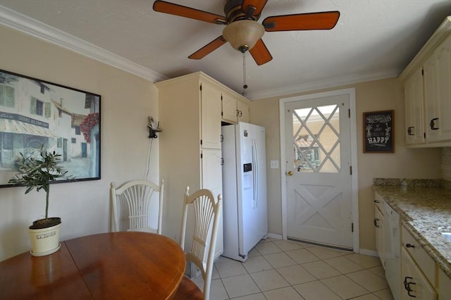 dining room featuring a ceiling fan, ornamental molding, and light tile patterned flooring
