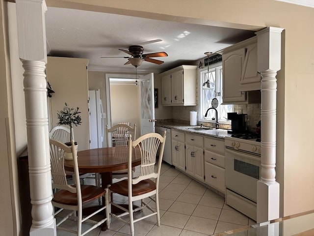 kitchen featuring a sink, decorative backsplash, white appliances, light tile patterned floors, and ceiling fan