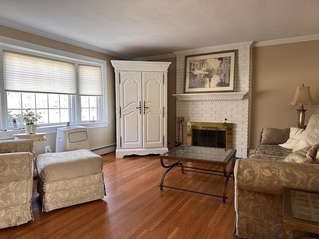 living area featuring wood finished floors, a brick fireplace, crown molding, and baseboard heating