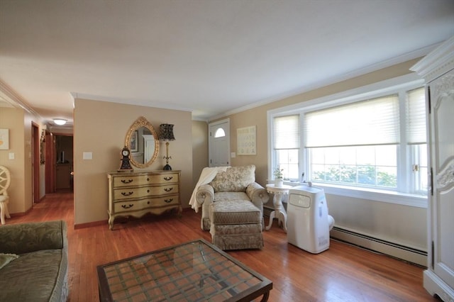 interior space with a baseboard heating unit, ornamental molding, and wood finished floors
