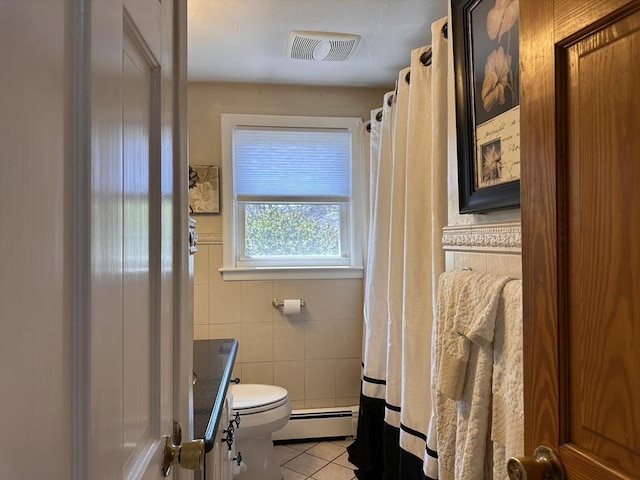 bathroom featuring baseboard heating, tile patterned floors, tile walls, toilet, and visible vents