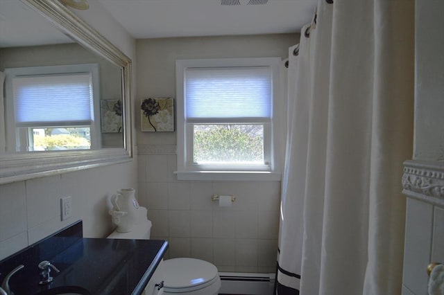bathroom featuring a baseboard heating unit, vanity, tile walls, a shower with curtain, and toilet