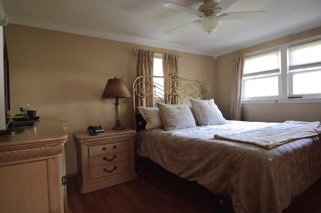 bedroom with ornamental molding, dark wood-style flooring, and multiple windows