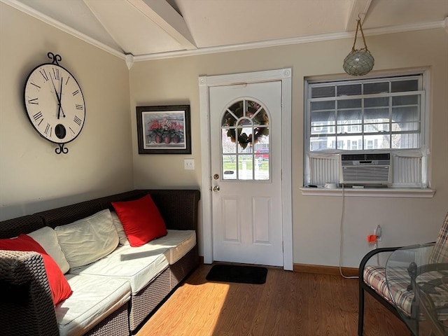 doorway featuring cooling unit, baseboards, lofted ceiling, wood finished floors, and ornamental molding