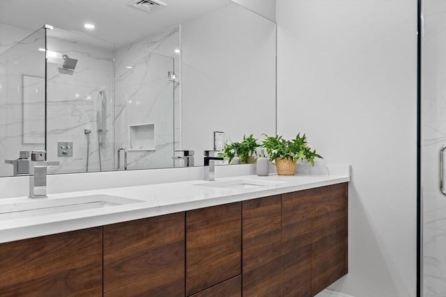 bathroom with vanity and a shower with door