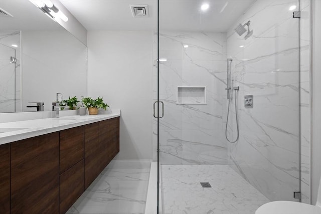 bathroom featuring vanity and an enclosed shower