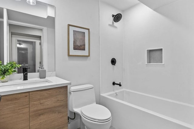 full bathroom with vanity, tiled shower / bath combo, and toilet